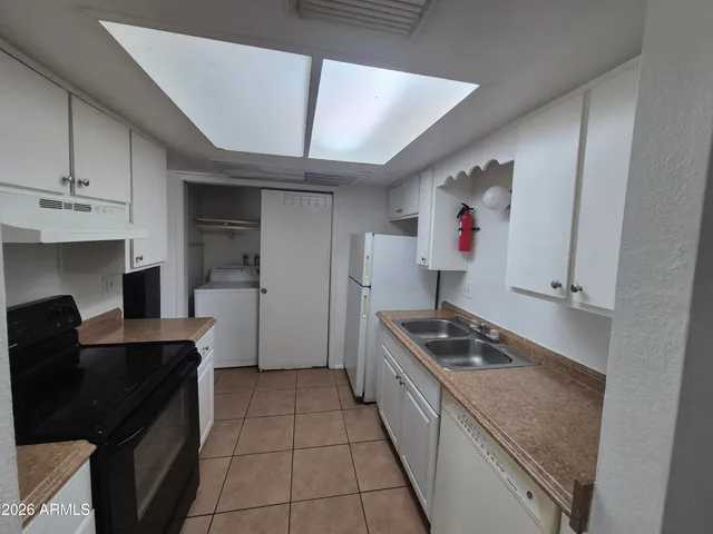 a kitchen with cabinets and window