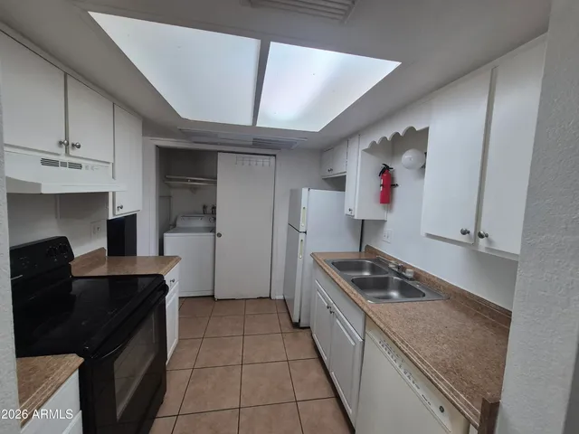 a kitchen with granite countertop a stove and a refrigerator