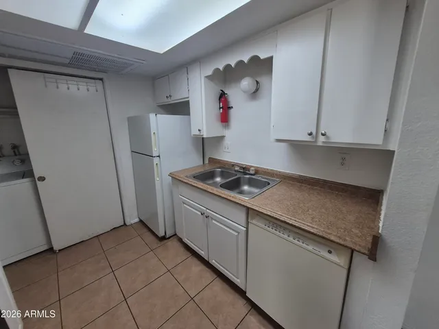 a kitchen with stainless steel appliances granite countertop a refrigerator and a stove