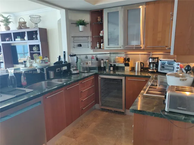 a kitchen with stainless steel appliances granite countertop a sink stove and cabinets
