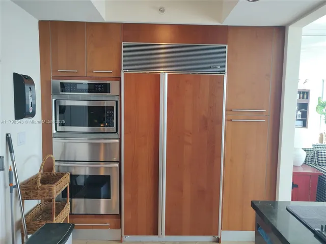 a kitchen with granite countertop stainless steel appliances and wooden cabinets