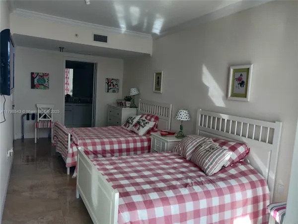 a bedroom with two beds and a dresser