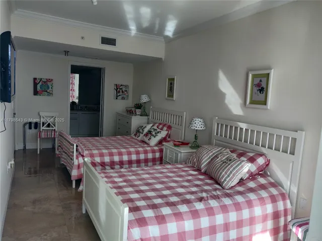 a bedroom with two beds and a dresser