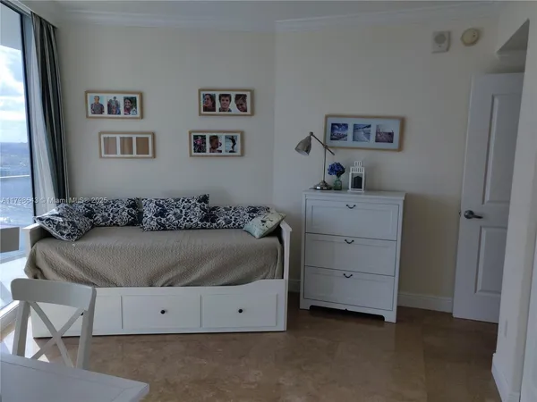 a living room with a dresser and a window