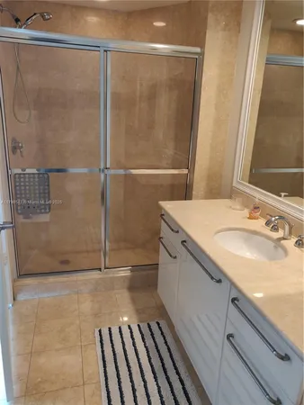 a bathroom with a shower and a sink