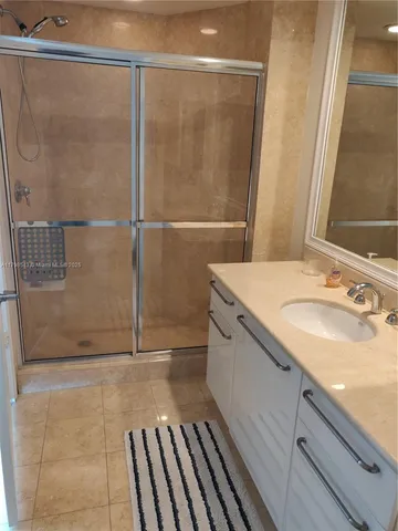 a bathroom with a shower and a sink