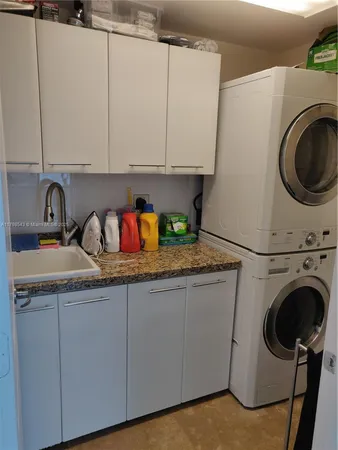 a kitchen with cabinets a sink and a stove top oven