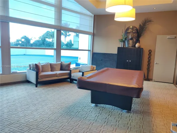 a living room with furniture and a floor to ceiling window