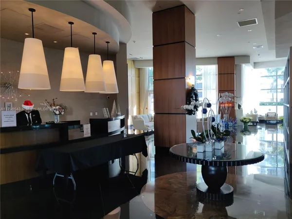 a living room with fireplace furniture and a large window