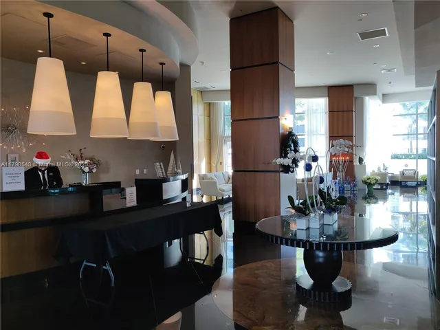 a living room with fireplace furniture and a large window