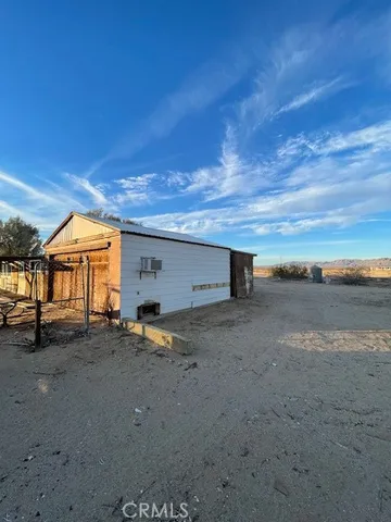 a view of a dirt road and a building
