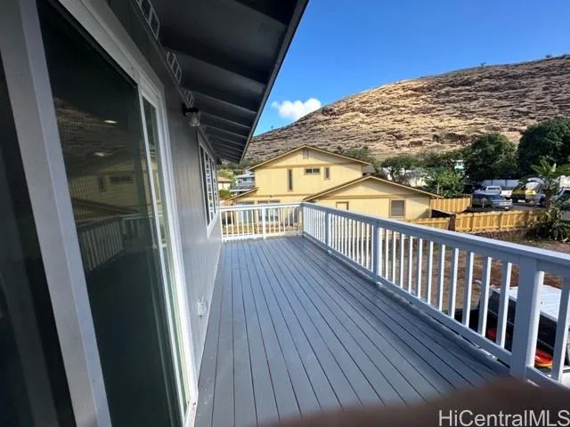 a view of balcony with wooden floor