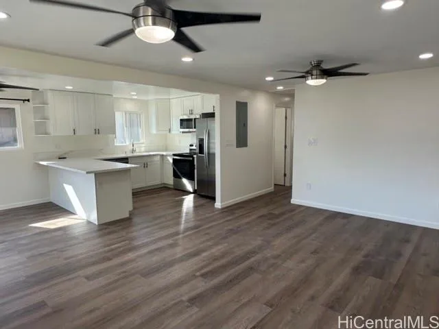 a view of kitchen with sink and wooden floor