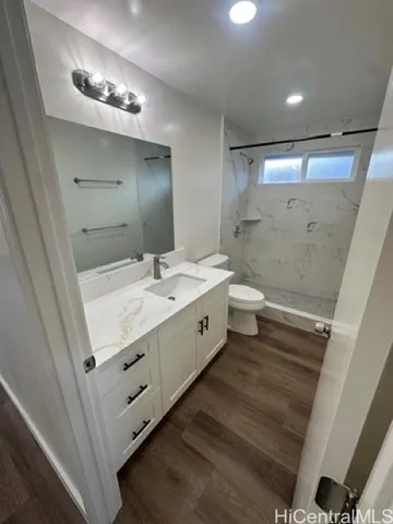 a spacious bathroom with a double vanity sink a toilet and a mirror