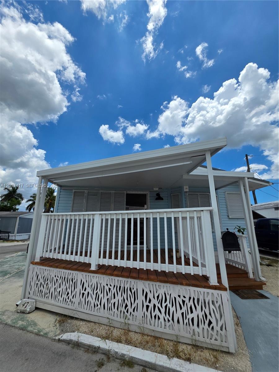 17350 Southwest 232nd Street, Unit 47 Miami, FL 33170 - Photo 1 of 9 a view of a porch with a bench