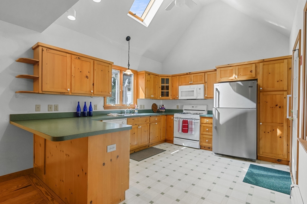10 Appleseed Road Eastham, MA 02642 - Photo 11 of 42 a kitchen with stainless steel appliances granite countertop a sink a stove and a refrigerator