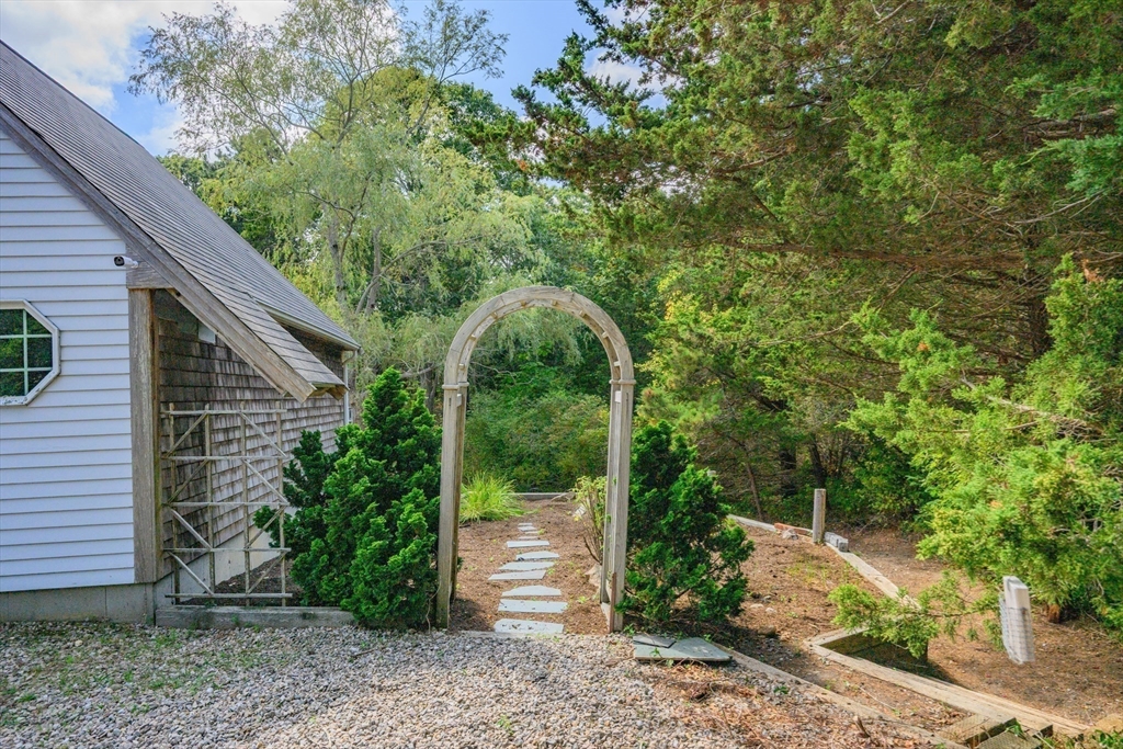 10 Appleseed Road Eastham, MA 02642 - Photo 35 of 42 a backyard of a house with plants and entertaining space