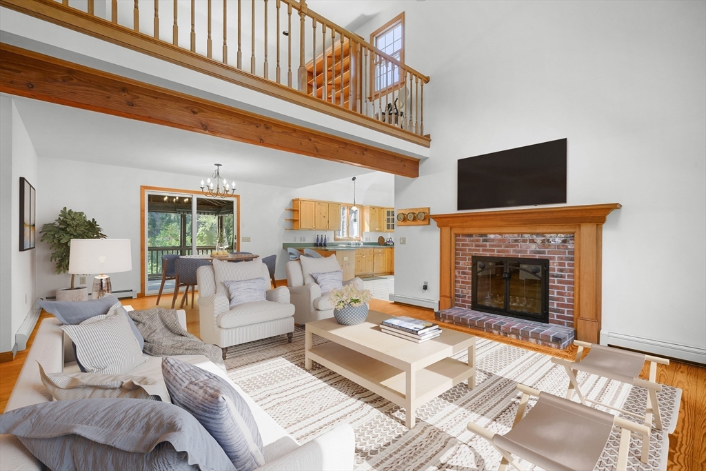 10 Appleseed Road Eastham, MA 02642 - Photo 7 of 42 a living room with furniture a fireplace and a flat screen tv