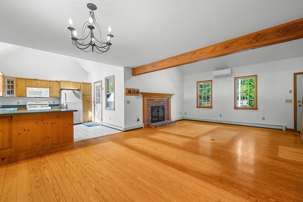 10 Appleseed Road Eastham, MA 02642 - Photo 10 of 42 a view of an empty room with a window and fireplace