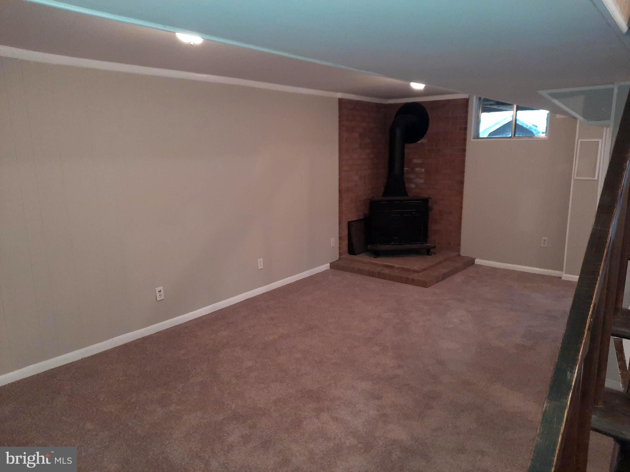 9072 Brook Ford Road Burke, VA 22015 - Photo 10 of 12 Basement Rec room with wood burning stove