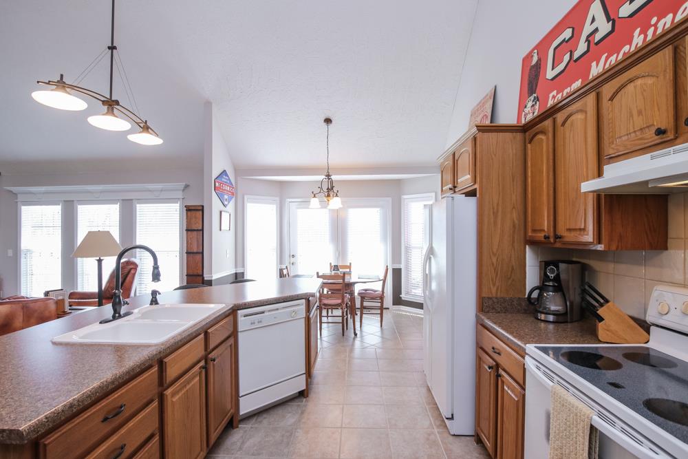 4079 Yeargan Road Murfreesboro, TN 37128 - Photo 11 of 30 a kitchen with lots of counter space a sink appliances and a dining table