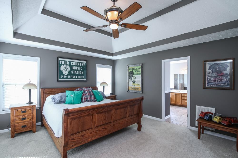4079 Yeargan Road Murfreesboro, TN 37128 - Photo 15 of 30 a bedroom with a bed and a chandelier