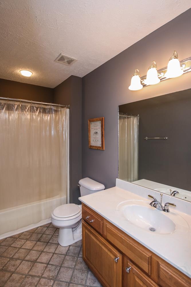 4079 Yeargan Road Murfreesboro, TN 37128 - Photo 20 of 30 a bathroom with a sink a toilet and a large mirror