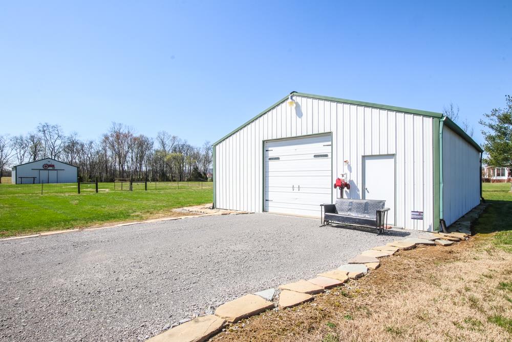 4079 Yeargan Road Murfreesboro, TN 37128 - Photo 26 of 30 a view of a house with backyard and trees in the background