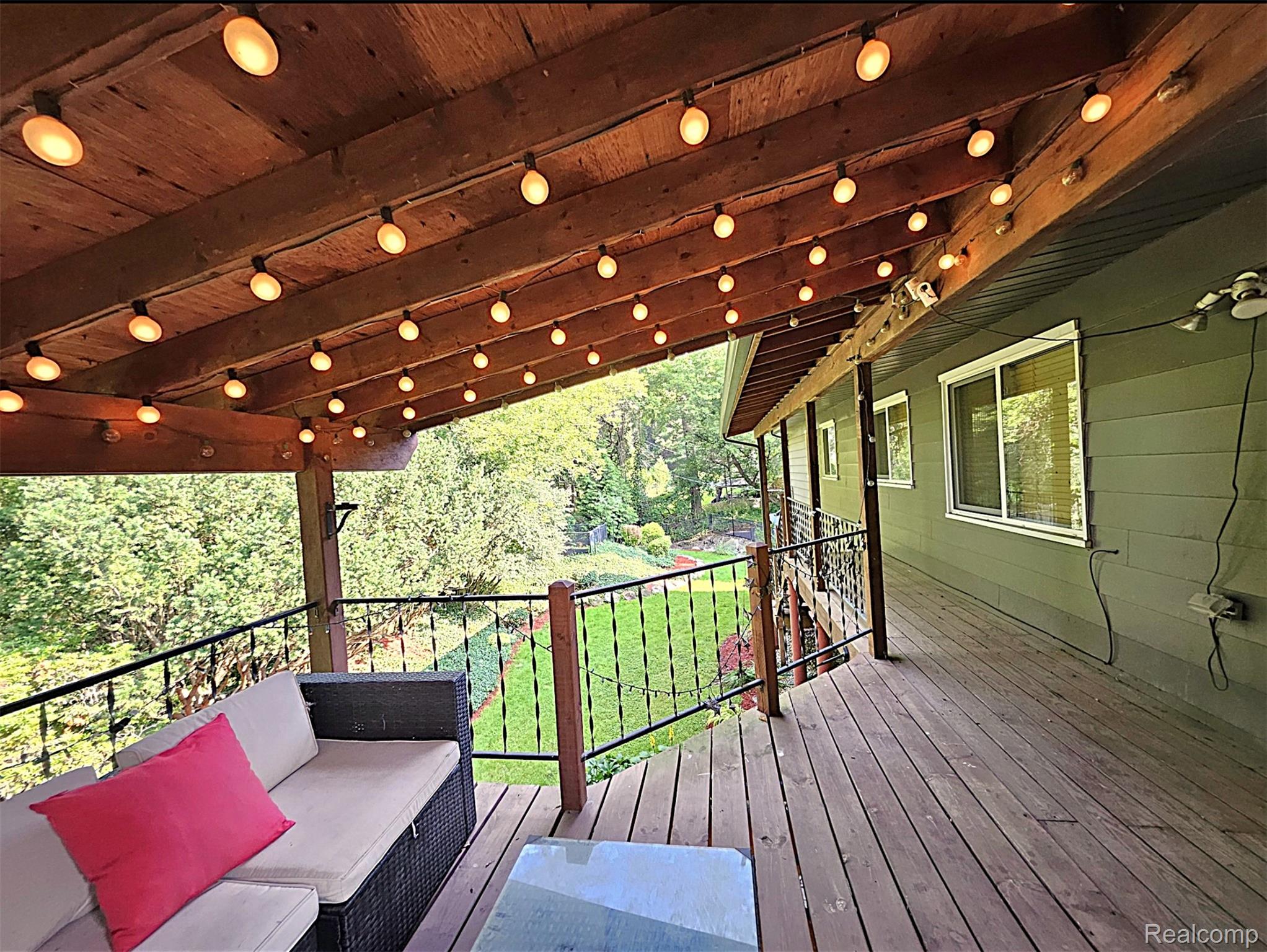 7120 Pebblecreek Road West Bloomfield, MI 48322 - Photo 5 of 31 Spacious outdoor deck featuring wood-finish flooring and a wood-paneled ceiling with string lighting