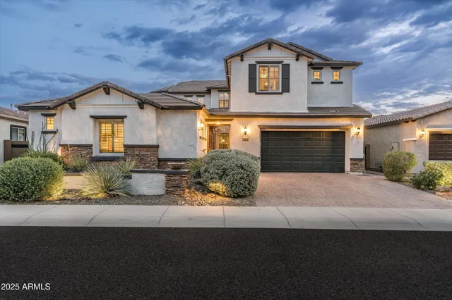 a front view of a house with a yard and garage