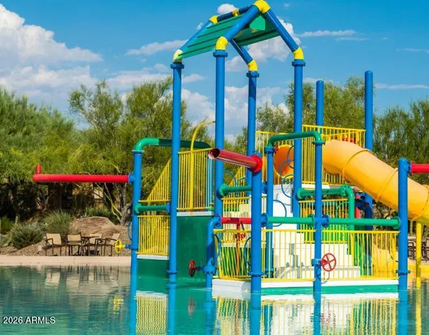 a view of swimming pool with sitting area