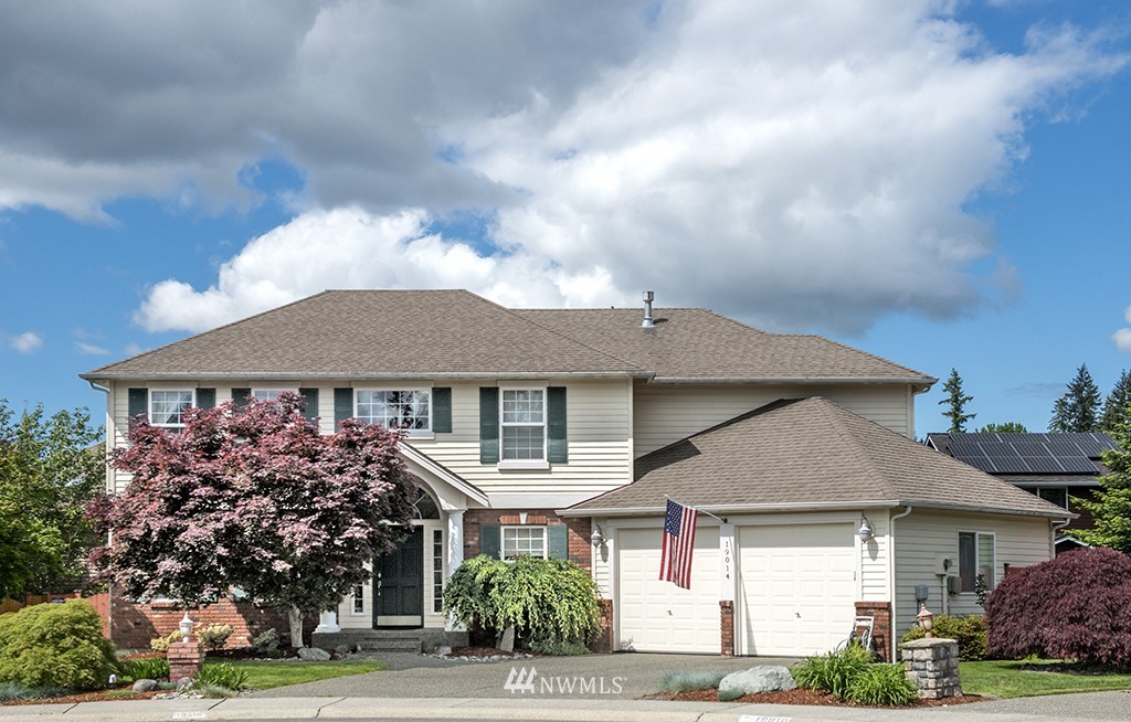 19014 33rd Avenue Southeast Bothell, WA 98012 - Photo 1 of 23 a front view of a house with a garden