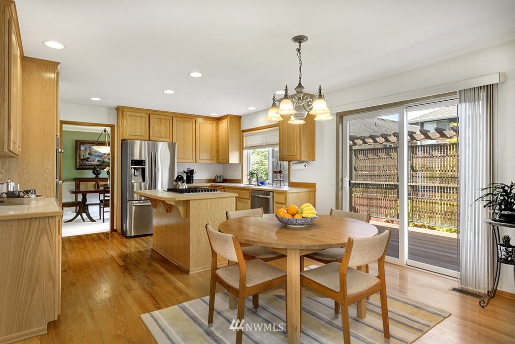 19014 33rd Avenue Southeast Bothell, WA 98012 - Photo 11 of 23 a view of a dining room and livingroom with furniture wooden floor a chandelier