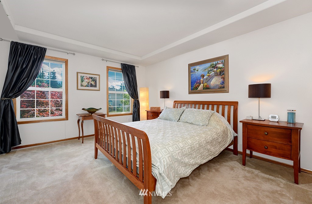 19014 33rd Avenue Southeast Bothell, WA 98012 - Photo 15 of 23 a spacious bedroom with a bed and a window