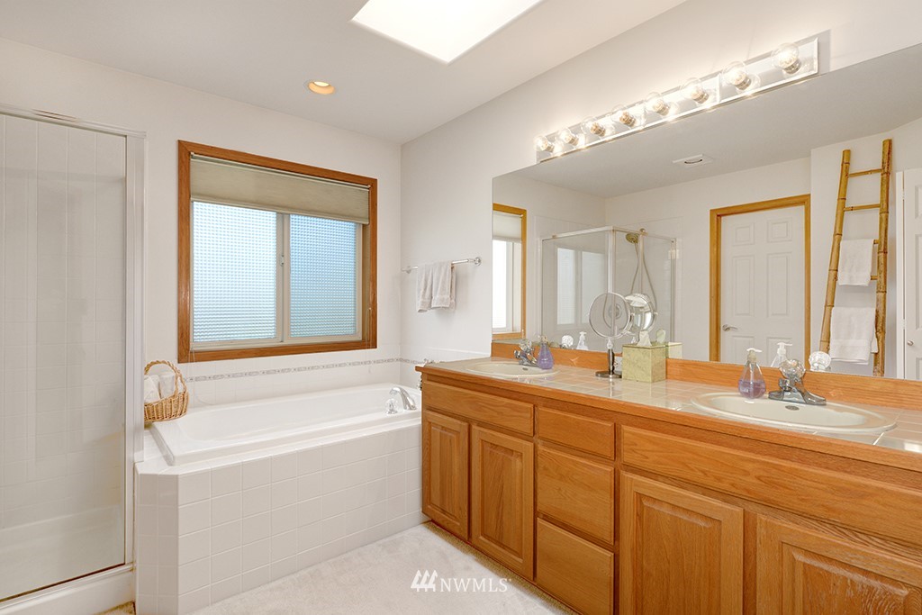 19014 33rd Avenue Southeast Bothell, WA 98012 - Photo 16 of 23 a bathroom with a granite countertop sink mirror and a bathtub
