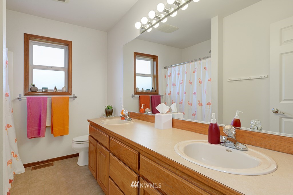 19014 33rd Avenue Southeast Bothell, WA 98012 - Photo 17 of 23 a bathroom with a sink double vanity and a tub
