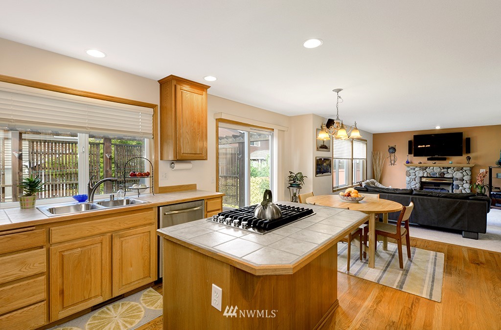 19014 33rd Avenue Southeast Bothell, WA 98012 - Photo 10 of 23 a kitchen with sink a stove and chairs