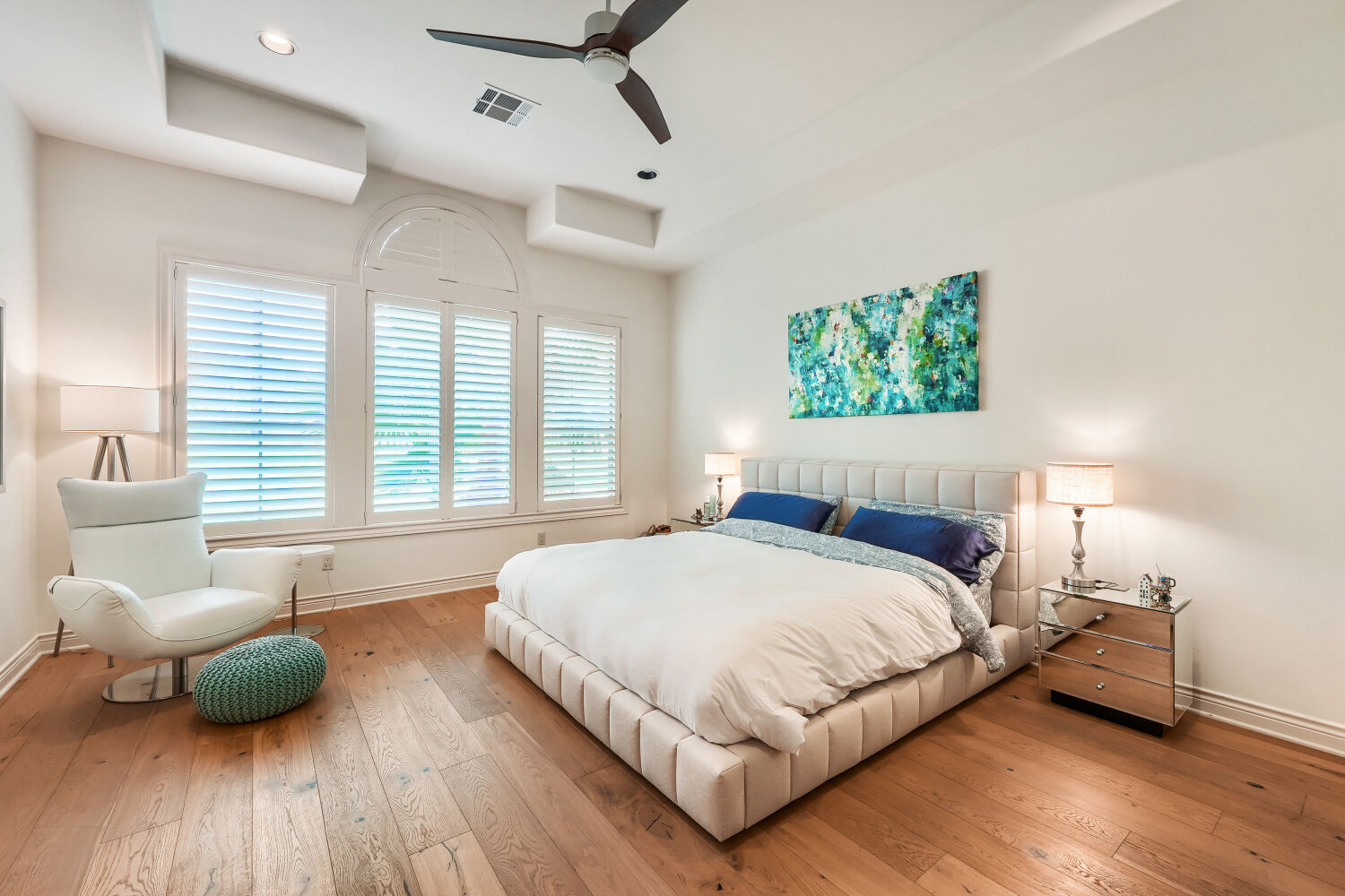701 Hurst Creek Road Lakeway, TX 78734 - Photo 14 of 37 Spacious Primary bedroom featuring updated wide plank wood-finish flooring, high ceilings, large windows to allow lots of natural lighting, and plantation shutters.
