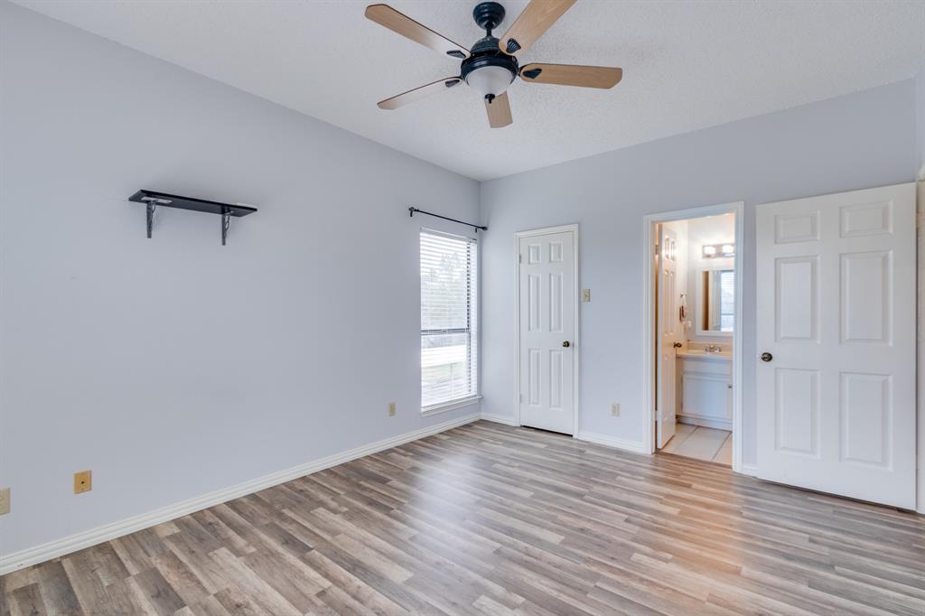2100 Randy Snow Road, Unit 412 Arlington, TX 76011 - Photo 21 of 32 a view of a room with wooden floor and ceiling fan