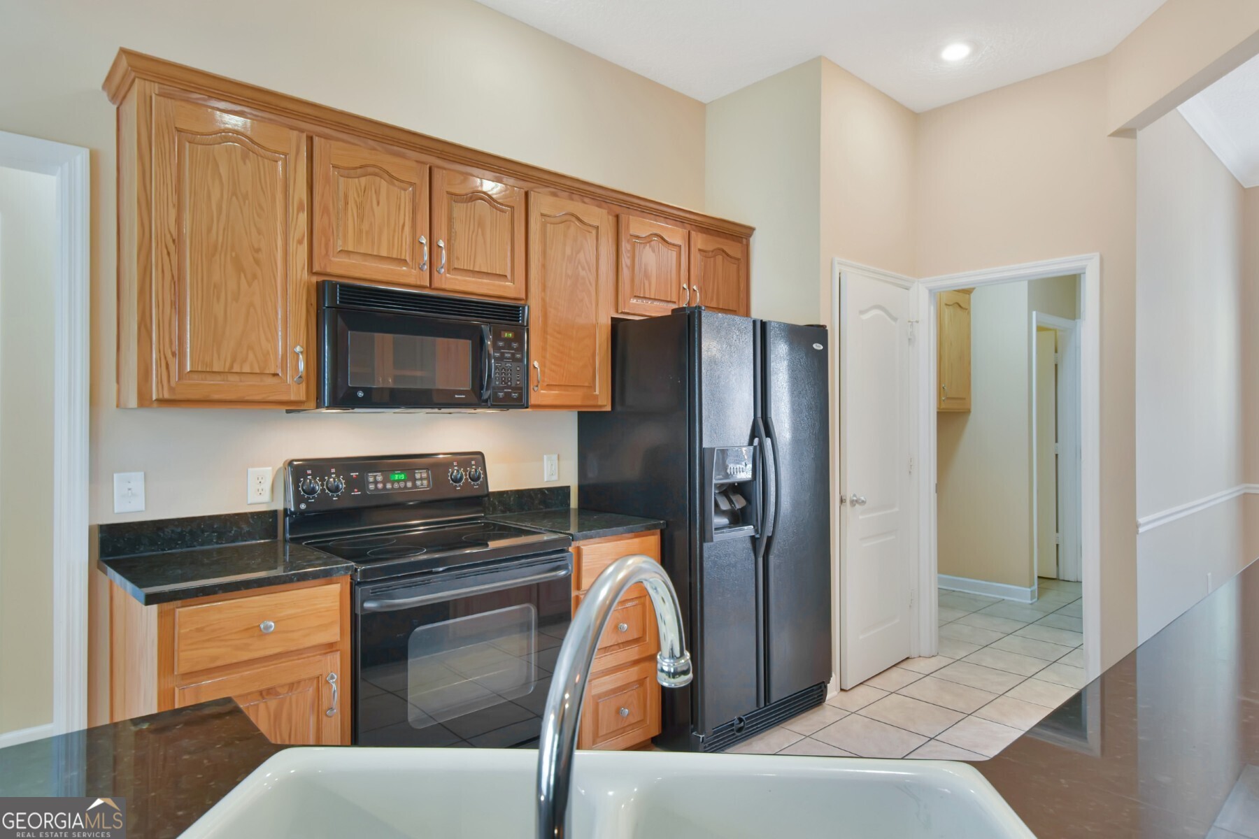138 Arlington Way Brunswick, GA 31523 - Photo 12 of 32 a kitchen with stainless steel appliances granite countertop a refrigerator stove and sink