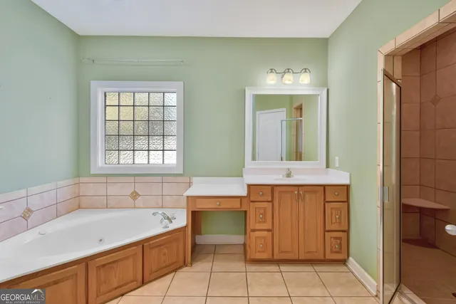 a bathroom with a tub sink and mirror
