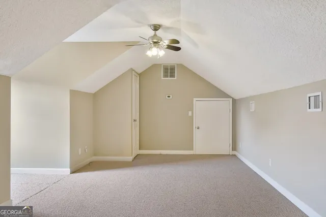 a view of an empty room with a fan