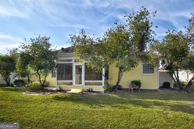 a view of a lake with houses in the back