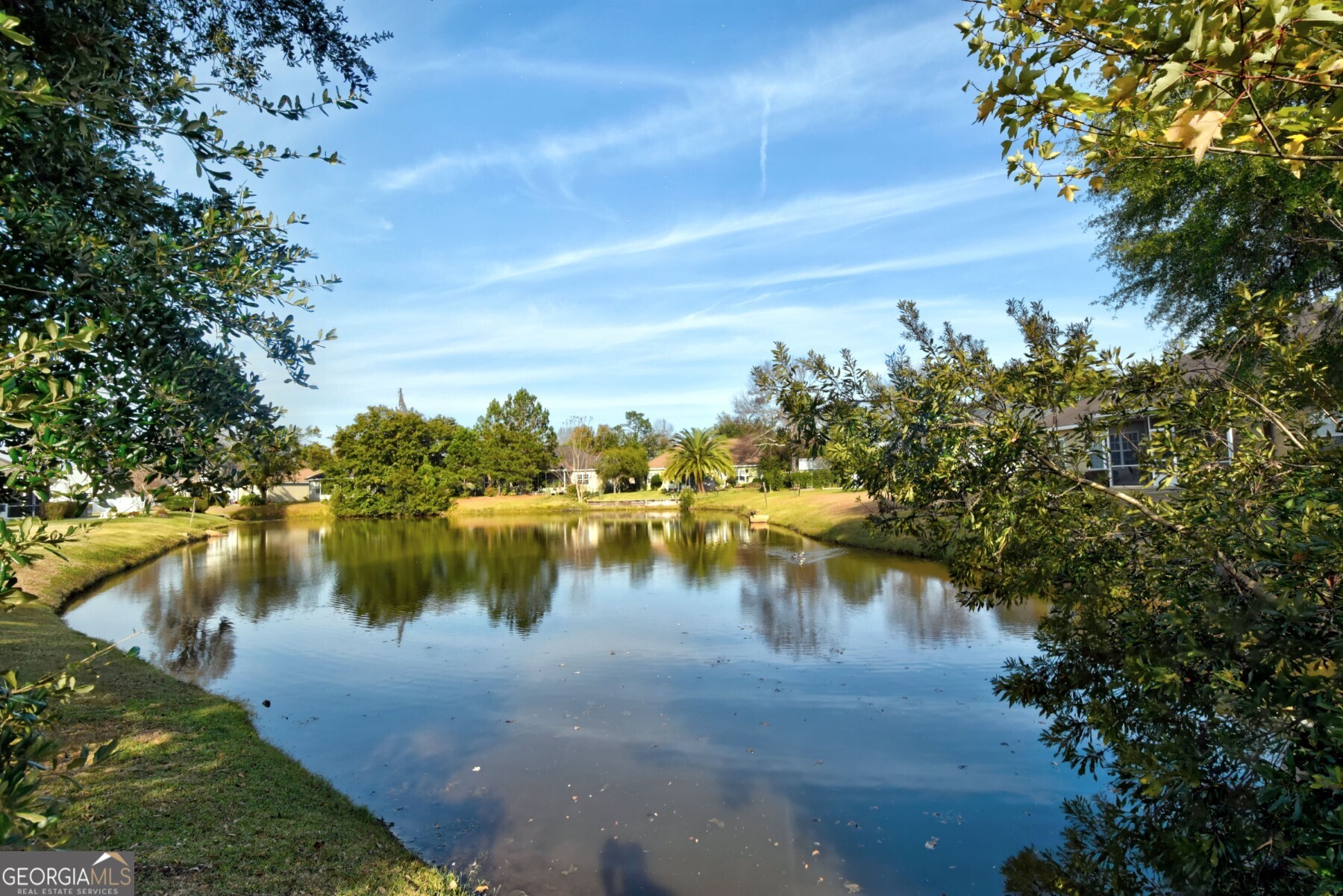 138 Arlington Way Brunswick, GA 31523 - Photo 27 of 32 a view of a lake with houses in the back
