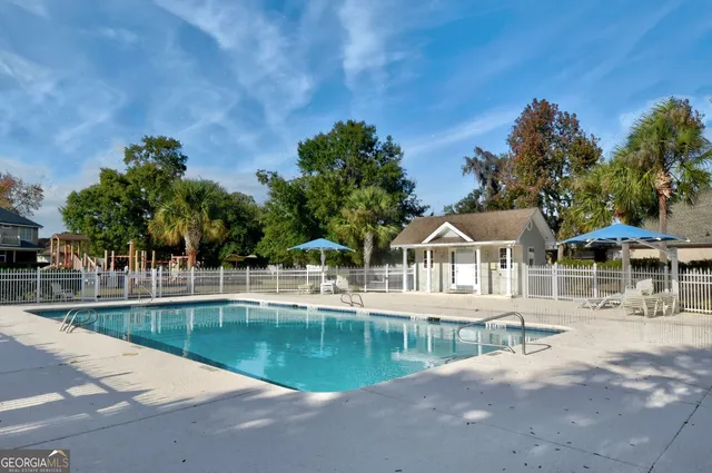 a view of a house with backyard water and trees