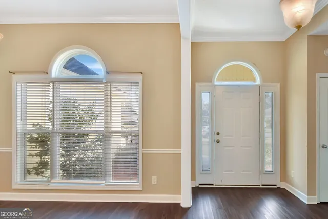 a view of a livingroom with wooden floor and a window