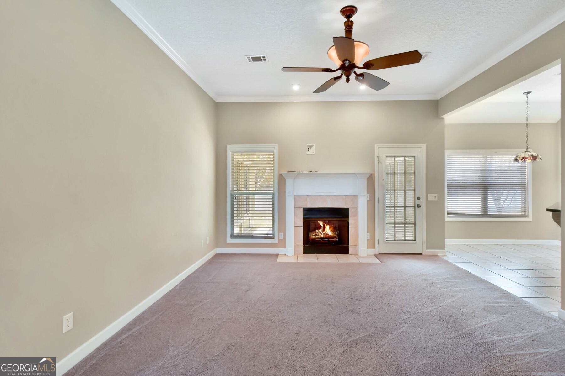 138 Arlington Way Brunswick, GA 31523 - Photo 6 of 32 a view of an empty room with a fireplace and a window