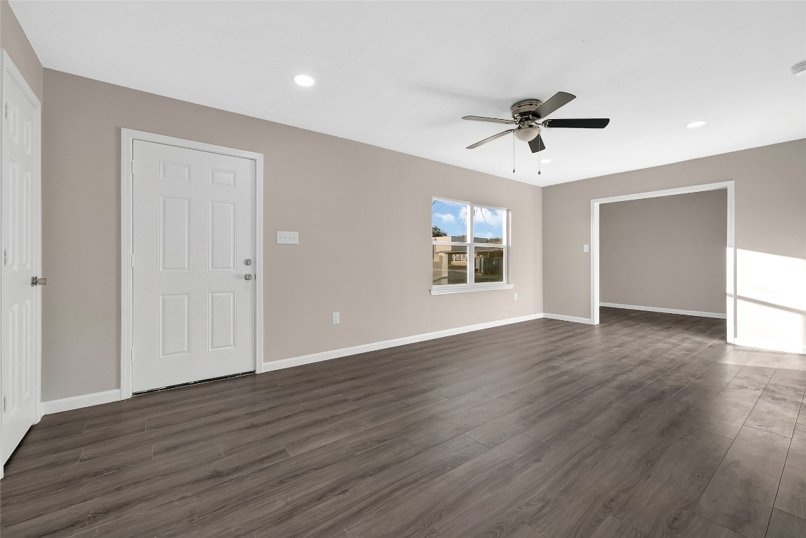 408 North Speed Street Wharton, TX 77488 - Photo 3 of 11 a view of an empty room with wooden floor and a window