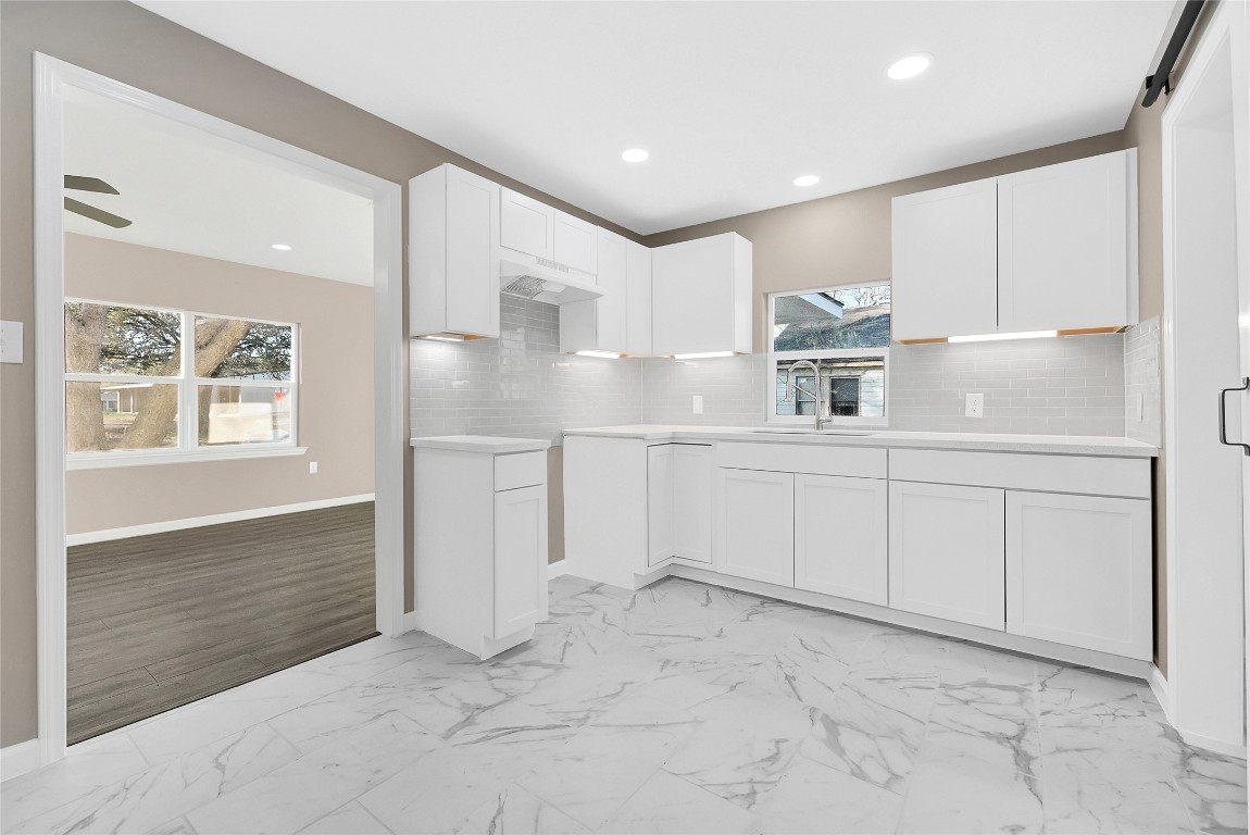 408 North Speed Street Wharton, TX 77488 - Photo 7 of 11 a kitchen with white cabinets and sink