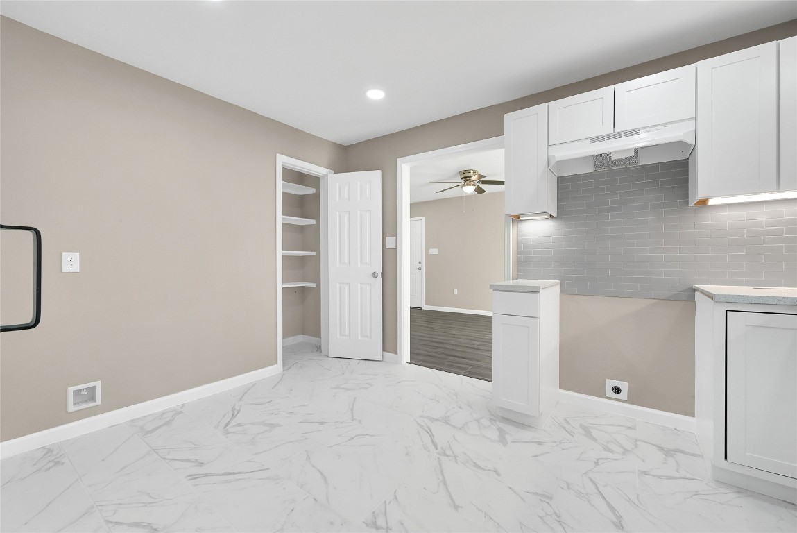 408 North Speed Street Wharton, TX 77488 - Photo 8 of 11 a view of empty room with kitchen and window